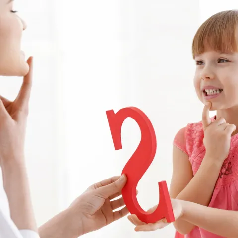 school speech-language pathologist helping child